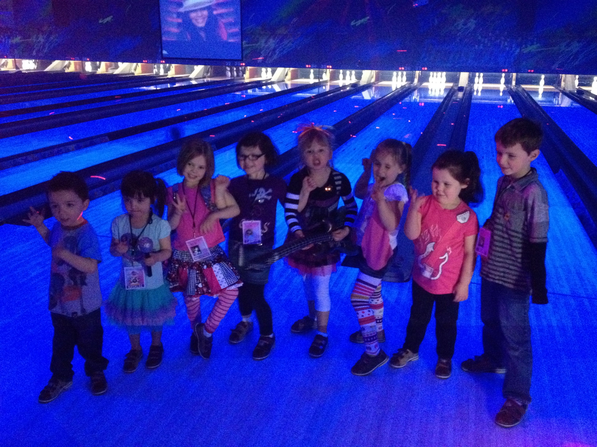 kids in cosmic bowling ball alley