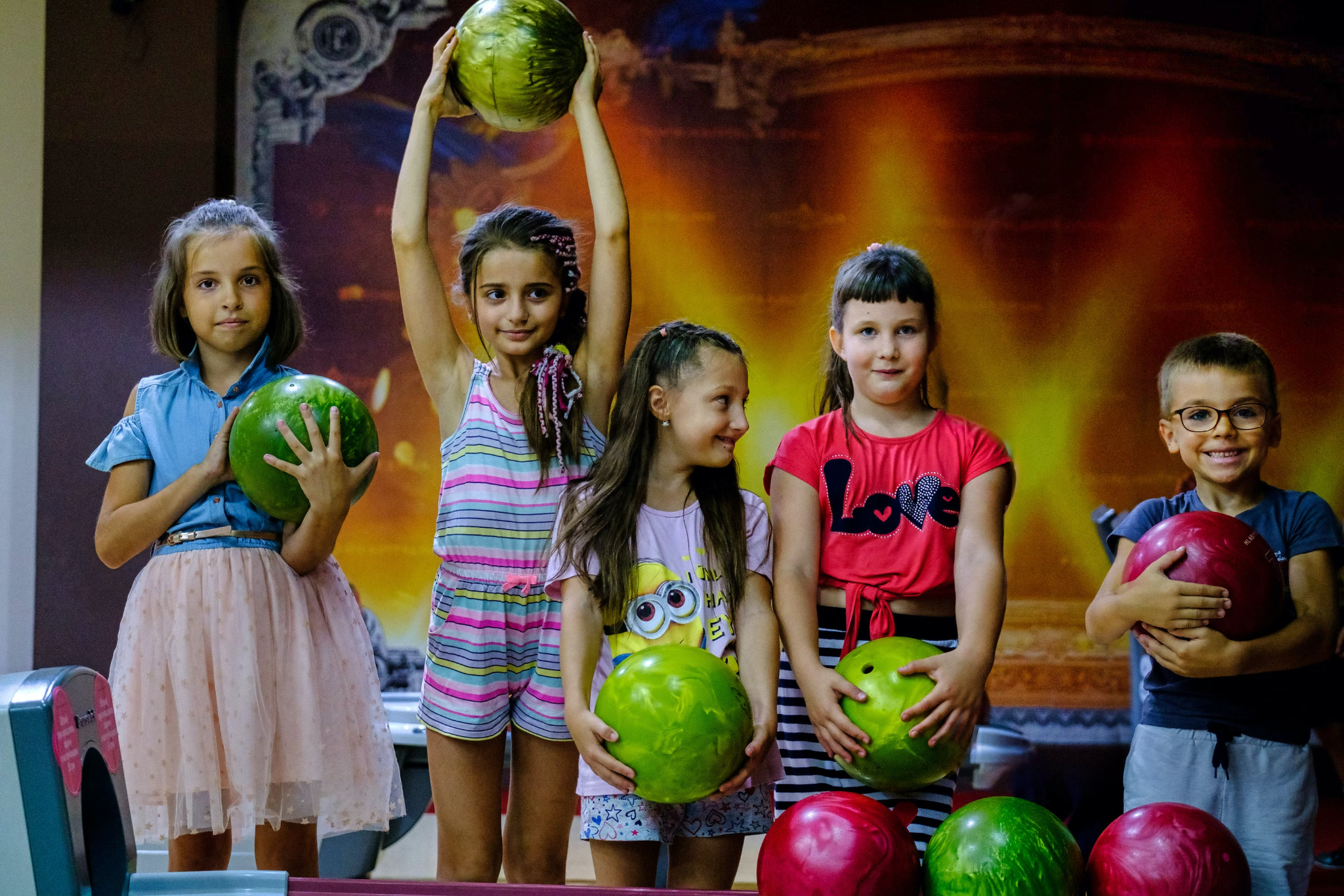 kids with colorful bowling balls
