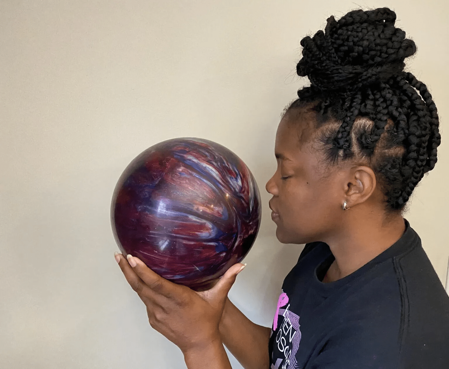 a person smelling a bowling ball